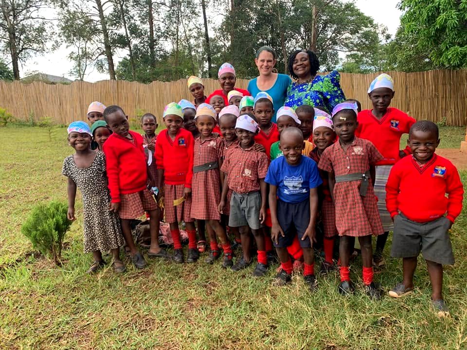 Marsha and Ugandan staff with children